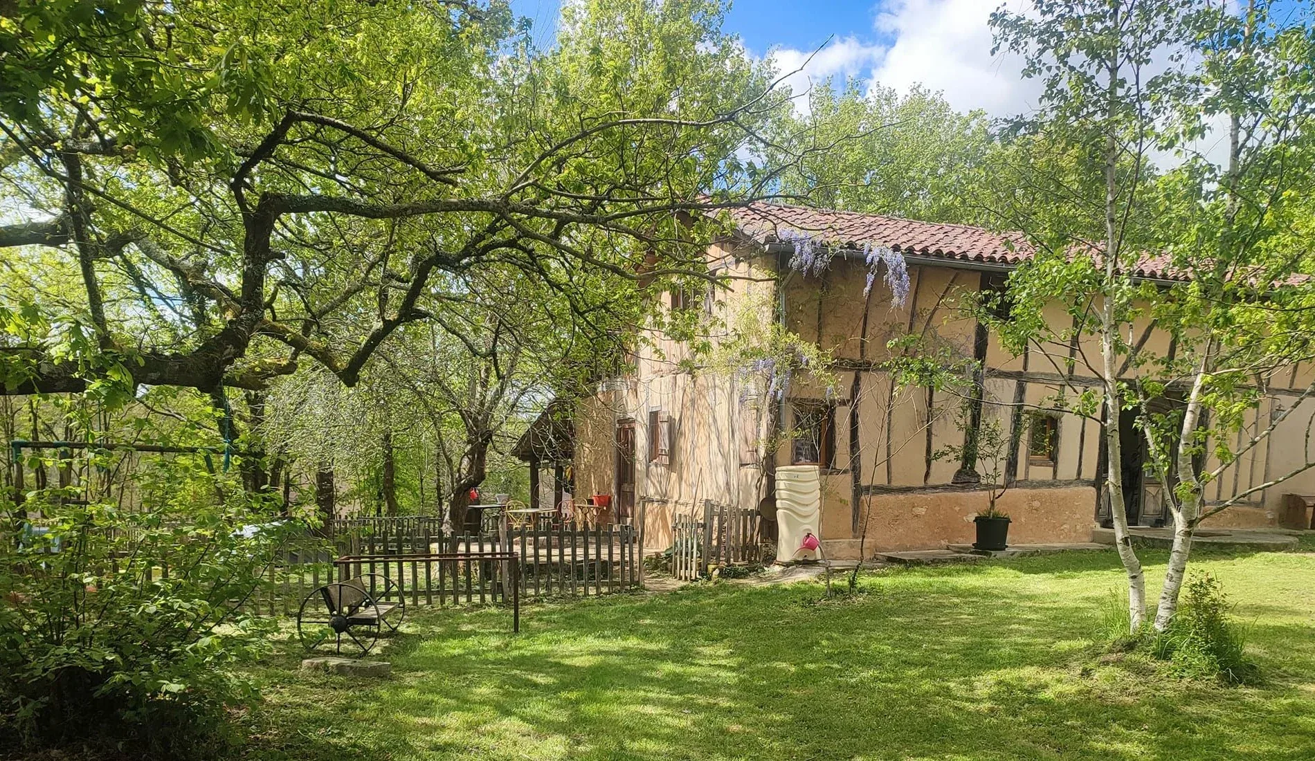 The main house and its tree-lined garden.