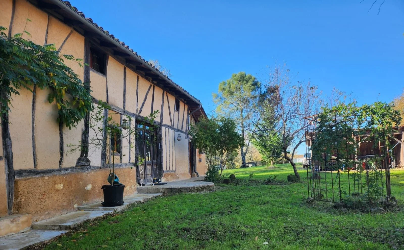 The timber-framed facade of the main house from the garden.